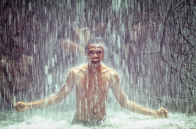 man-under-waterfall-2150164_640